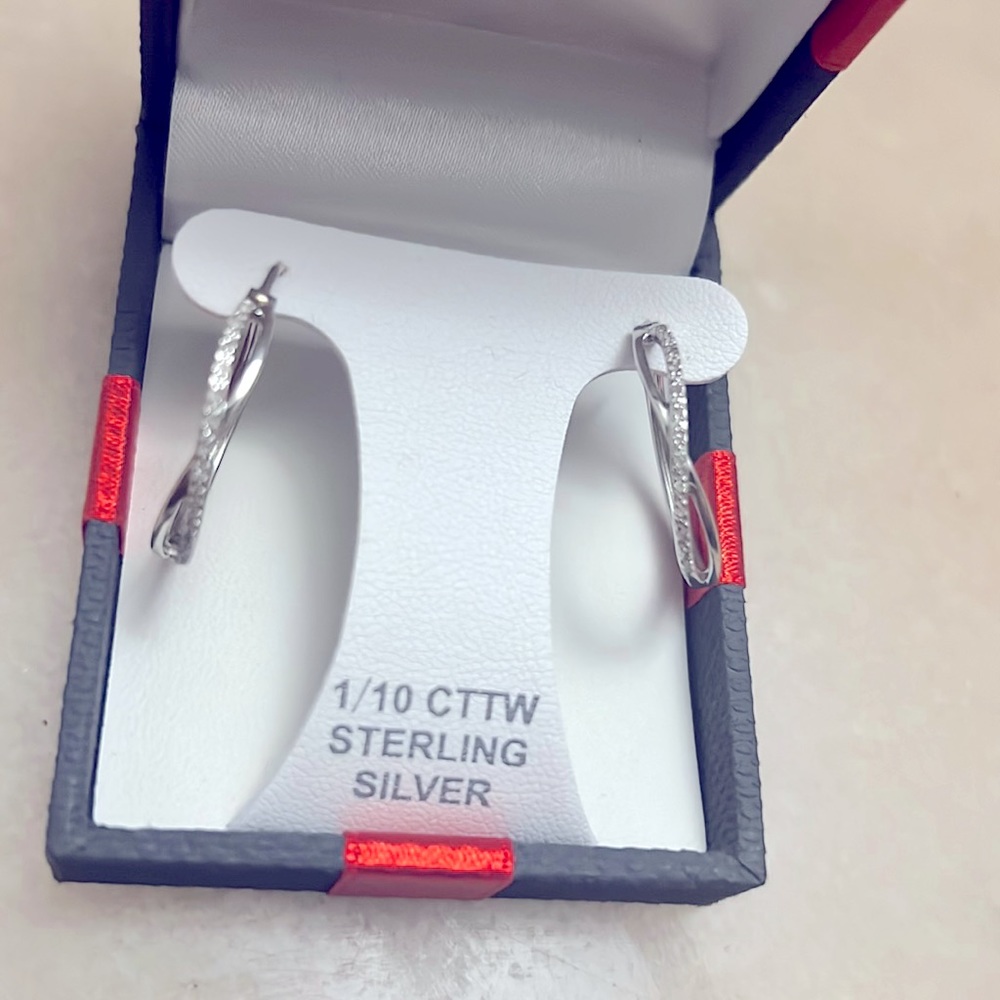 Sterling silver with real diamonds small hoop earrings.